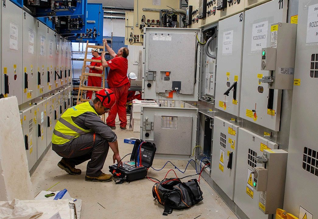 Engineers performing testing of MV switchgear